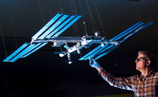 Technician Alistair MacKillop with a Lego model of the International Space Station