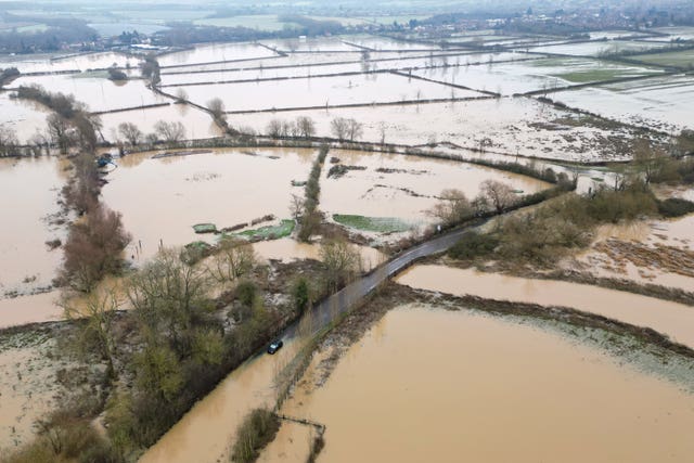 Aerial view of winter fields covered in muddy brown flood water