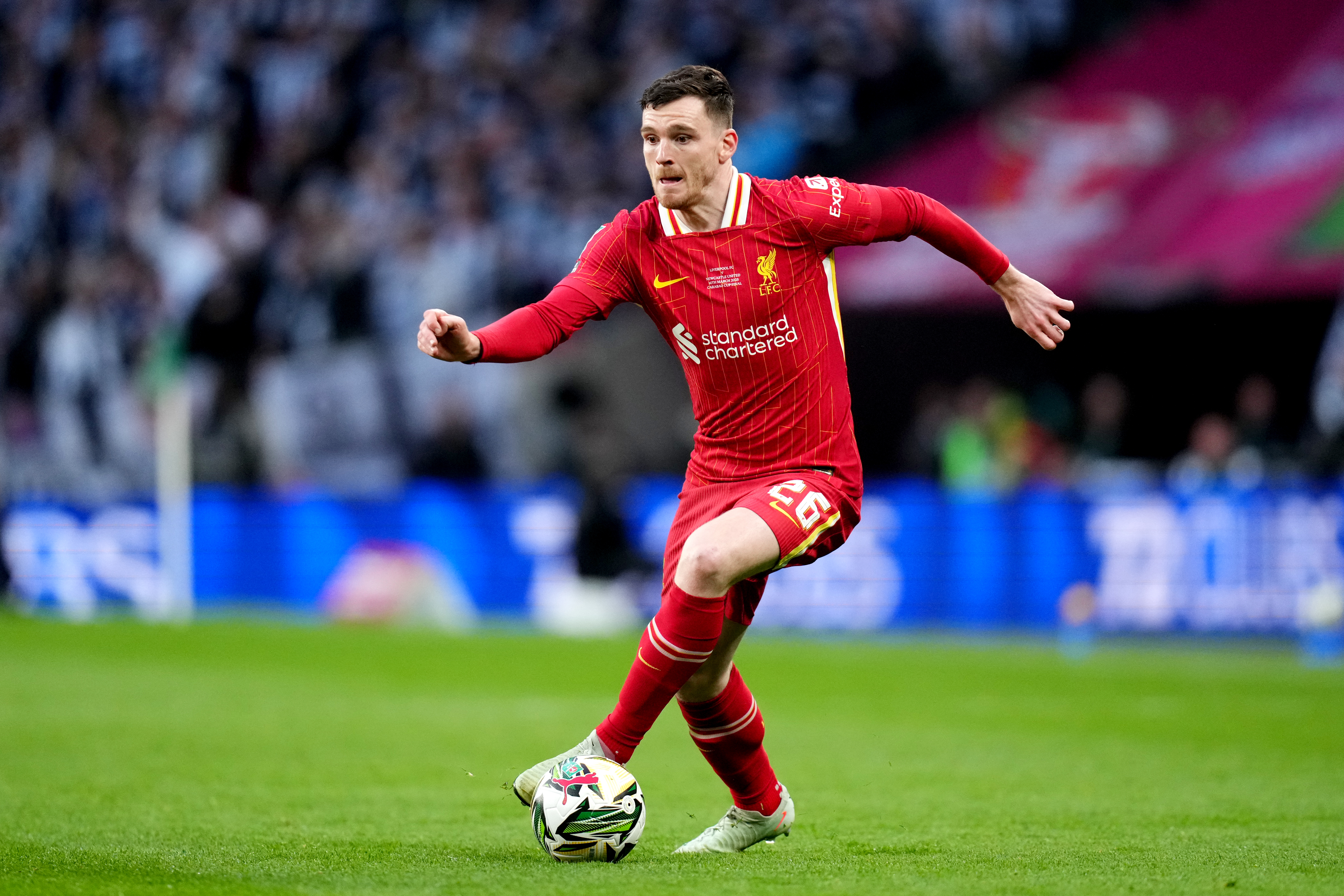 Andy Robertson dribbles the ball