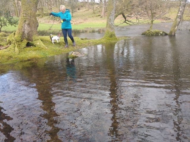 PCSO Julia James walking her Jack Russell Toby and wearing a light blue waterproof coat, blue jeans and dark coloured Wellington style brown boots - the same clothes she had on when last seen before her murder