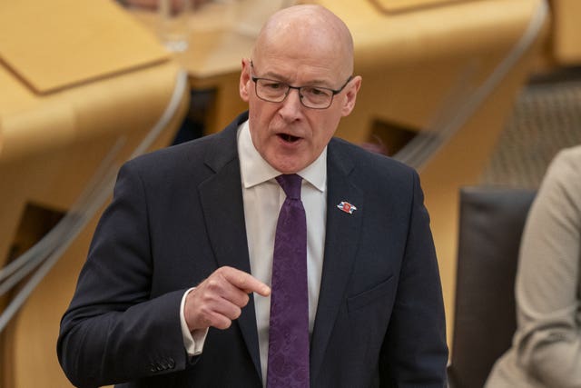 John Swinney standing while speaking in Holyrood