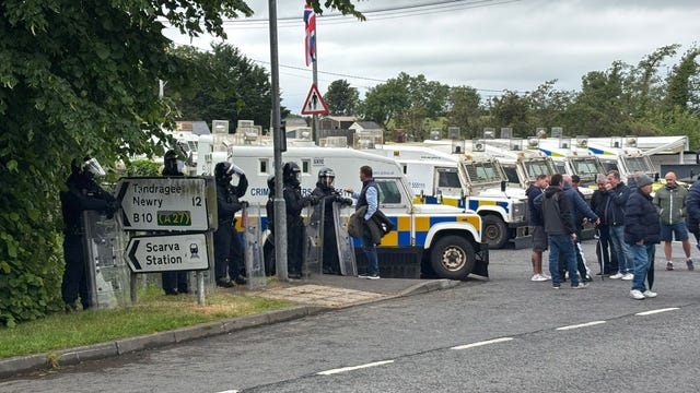 PSNI officers in riot gear with armoured vans separate counter-protesters as the pro-Palestinian march from Lurgan to Newry passes Scarva, Co Down