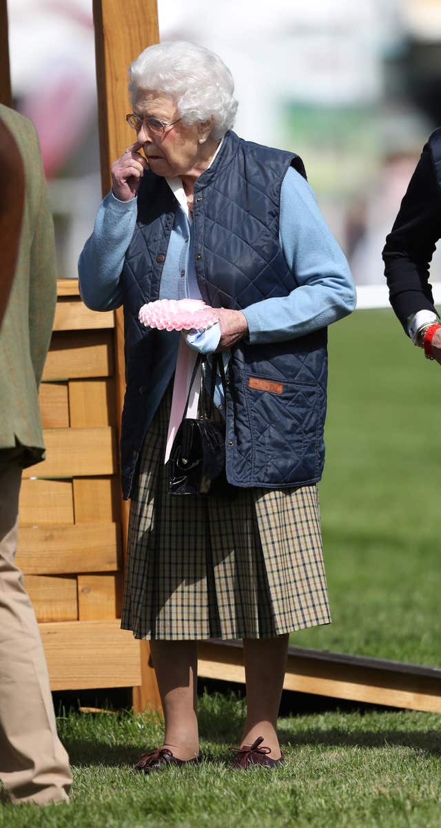 The Queen holding a rosette after her horse finished 5th (Steve Parsons/PA)