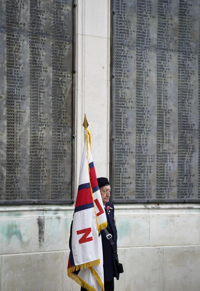 A standard bearer at the WWI memorial, Guildhall Square, in Portsmouth, as people gather to remember the war dead on Armistice Day