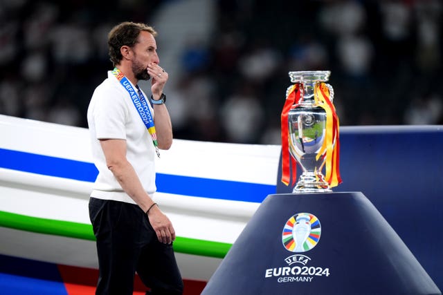 England manager Gareth Southgate walks dejected past the European Championship trophy