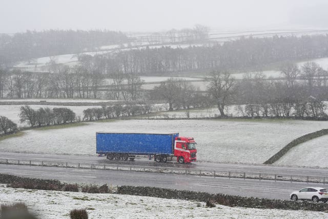 A lorry driving on the A66 as a light blanked of snow covered the surrounding fields