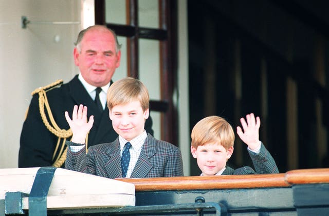 Prince William, nine, and his younger brother Prince Harry, seven, wave to photographers as they board the Royal Yacht Britannia (Martin Keene/PA)