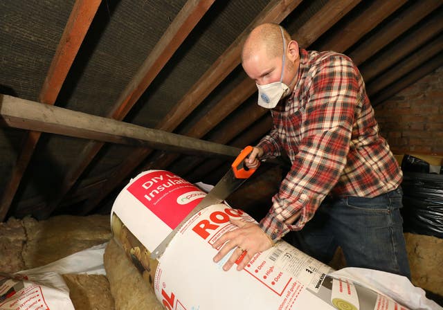 Richard Burr doing loft insulation (Philip Toscano/PA)