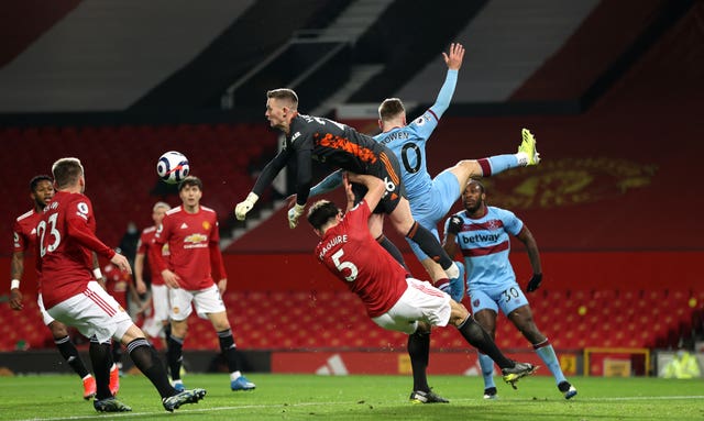 Dean Henderson, centre, punches clear under pressure from Jarrod Bowen, second right