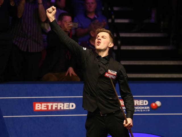 James Cahill celebrates after beating Ronnie O'Sullivan 10-8 