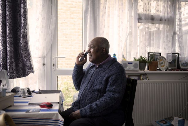 Michael, 71, chatting to a volunteer called Gemma from Age UK