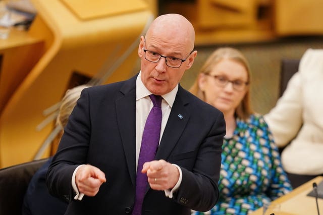 John Swinney standing while speaking in Holyrood