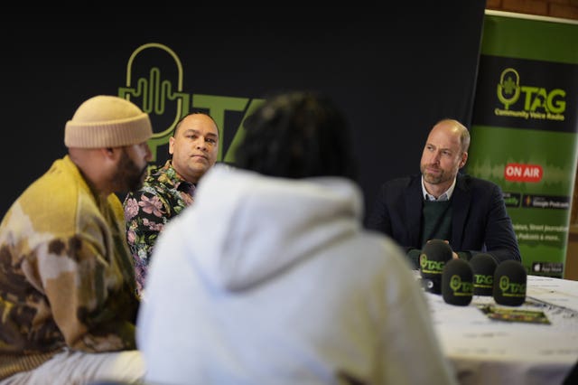 Prince of Wales sitting at a table with podcasters