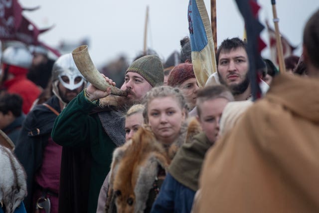 Re-enactors make their way on to the beach