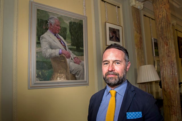 Artist Gareth Reid with the portrait