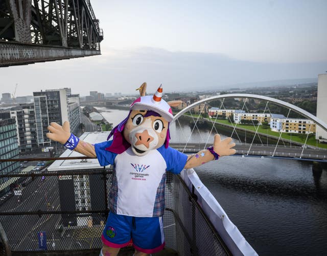 The Glasgow 2026 Commonwealth Games mascot stands on a vantage point overlooking the Clyde river