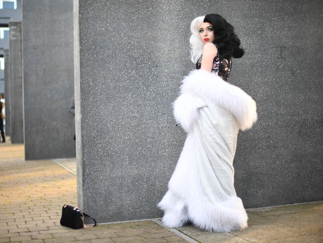 A cosplayer dressed as Cruella de Vil