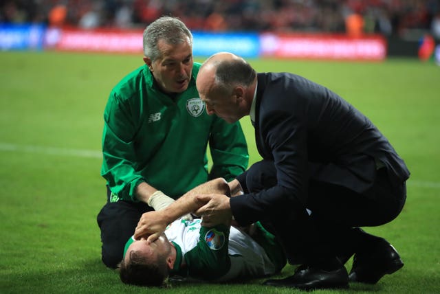 Midfielder Alan Judge receives treatment on the pitch after fracturing his wrist