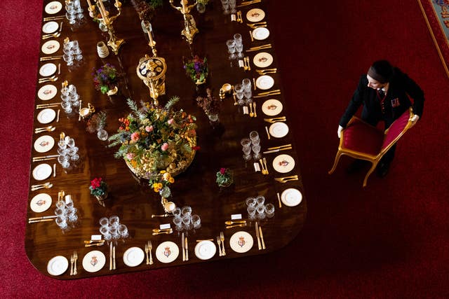A chair is moved into position at the banquet table