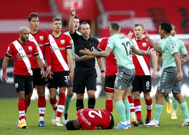 Everton’s Lucas Digne is shown a red card by referee Kevin Friend