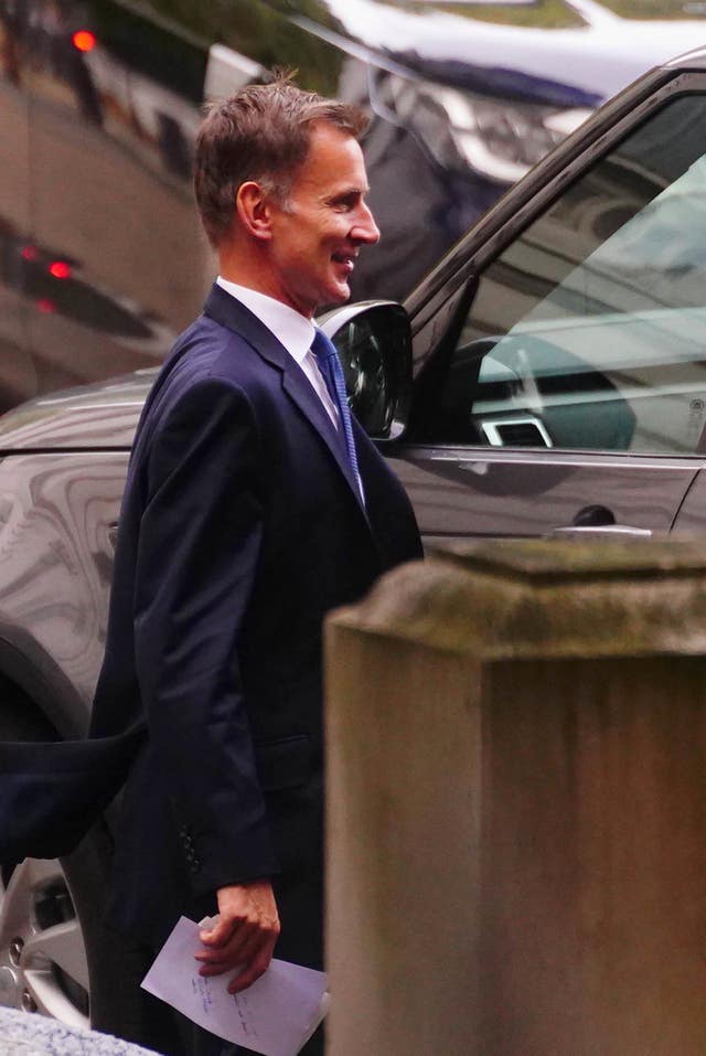 Chancellor Jeremy Hunt getting into a car at the rear of Downing Street, London, before making his emergency statement