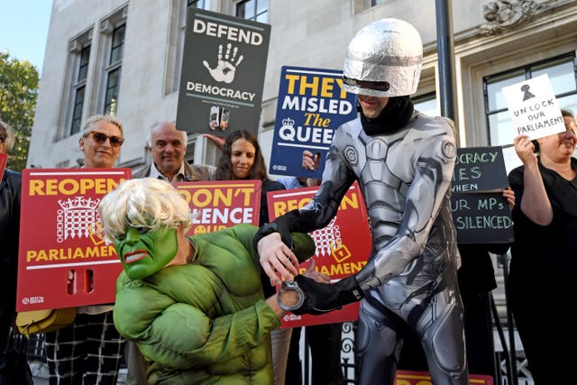 Protesters dressed as the Incredible Hulk and Robocop outside the Supreme Court in London