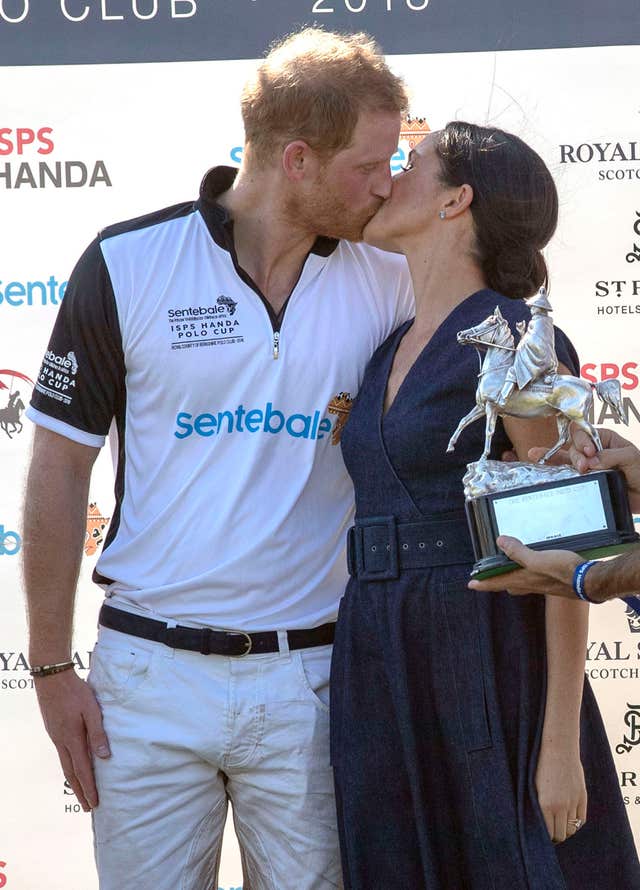 Harry and Meghan kiss at the polo