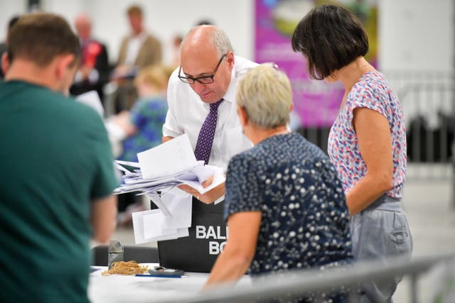 Votes are taken from a ballot box during the count of votes in the Brecon and Radnorshire by-election in August 2019 (Ben Birchall/PA)