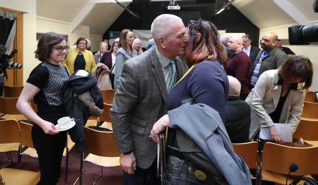 Jackie McDonald of Ulster Defence Association is hugged by a well wisher at a press conference at Linenhall Library, Belfast (Niall Carson/PA)