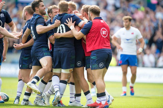 Scotland players celebrate with Chris Harris after he scored Scotland's second try