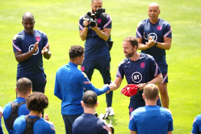Gareth Southgate gives James Justin his cap after his debut on Saturday