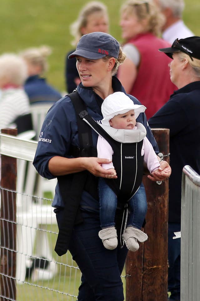 Zara walks with her daughter Mia during the St James's Place Wealth Management Barbury International Horse Trials in Wiltshire (Steve Parsons/PA)