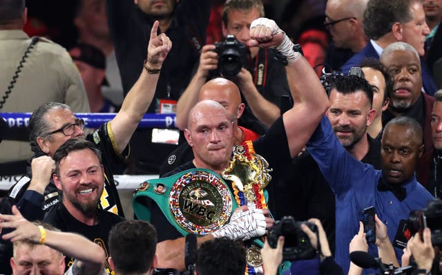 Tyson Fury, centre, is the WBC heavyweight champion (Bradley Collyer/PA)