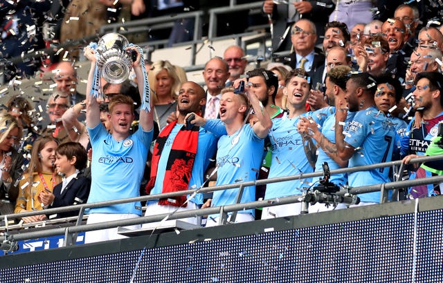Pep Guardiola tries to play down talk of Manchester City winning the treble