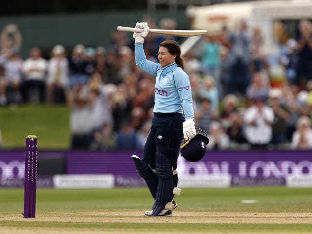 England's Tammy Beaumont raises her bat after scoring a century in the one-day international against New Zealand at Canterbury