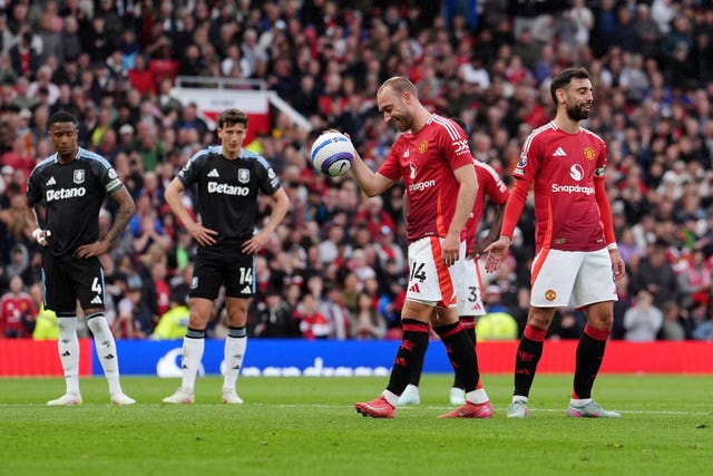 Manchester United’s Bruno Fernandes, right, gives the ball to Christian Eriksen to take his side's penalty against Aston Villa