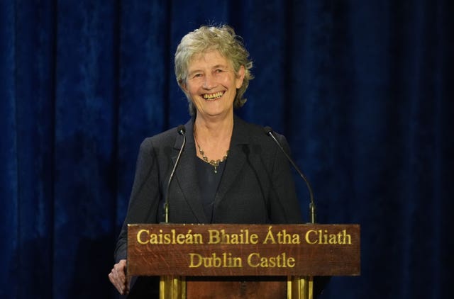 Catherine Connolly smiles at a lectern