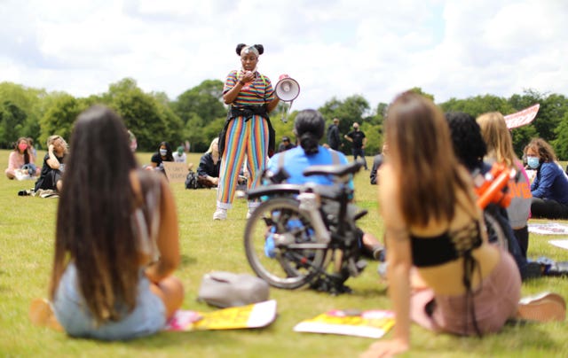 People listen to a speaker during Black Lives Matter rally in Hyde Park, London