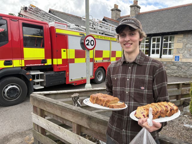 Tom Lake, 21, takes food to firefighters in Nethy Bridge, near to the wildfire in the Cairngorms