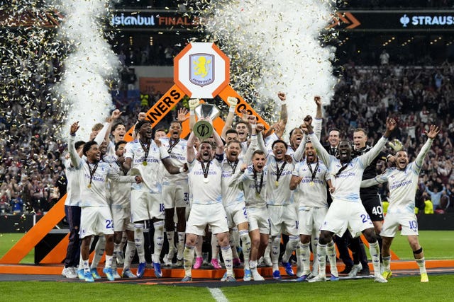Aston Villa’s John McGinn (centre) lifts the trophy with team-mates after winning the Europa League final at Besiktas Park, Istanbul