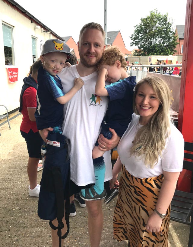 Archie Wilks with his parents Simon and Harriet and his identical twin brother Henry