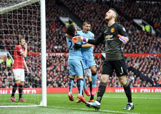 Sergio Aguero (centre right) celebrates scoring with team-mate David Silva (centre left) at Old Trafford