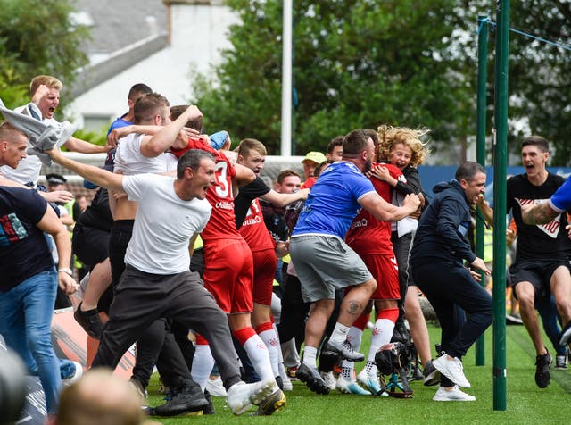 Rangers fans run on to the pitch to celebrate Connor Goldson's stoppage-time winner at Kilmarnock 