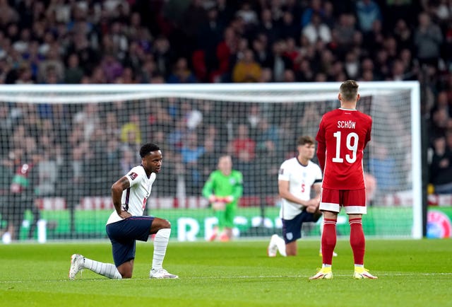 England''s Raheem Sterling takes a knee as Hungary''s Szabolcs Schon remains standing