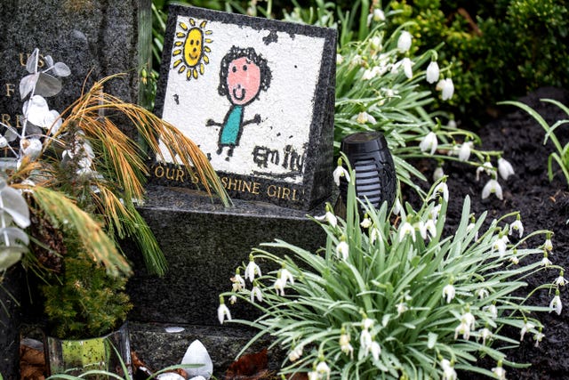 Floral tribute and child's picture of a child