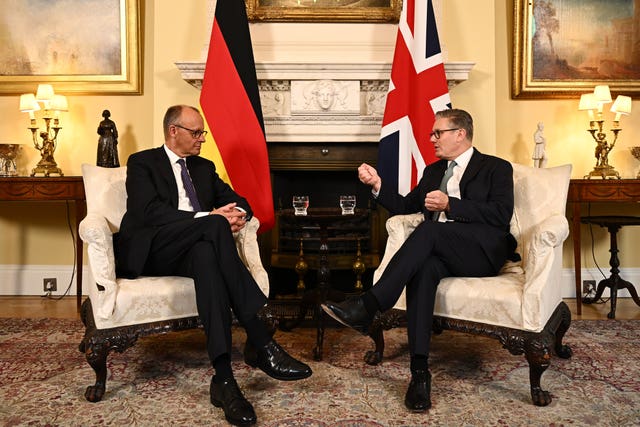 Friedrich Merz sitting on a chair facing Sir Keir Starmer at Downing Street