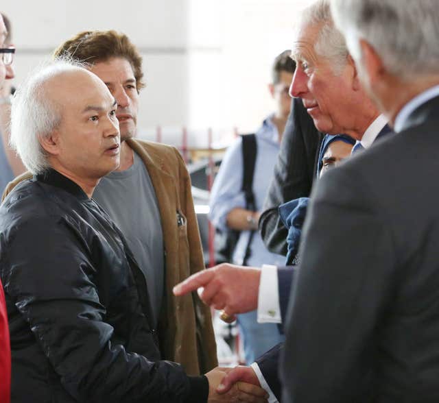 Anh Nhu Nguyen (left, dark shirt) met the Prince of Wales in the aftermath of the blaze (Philip Toscano/PA)