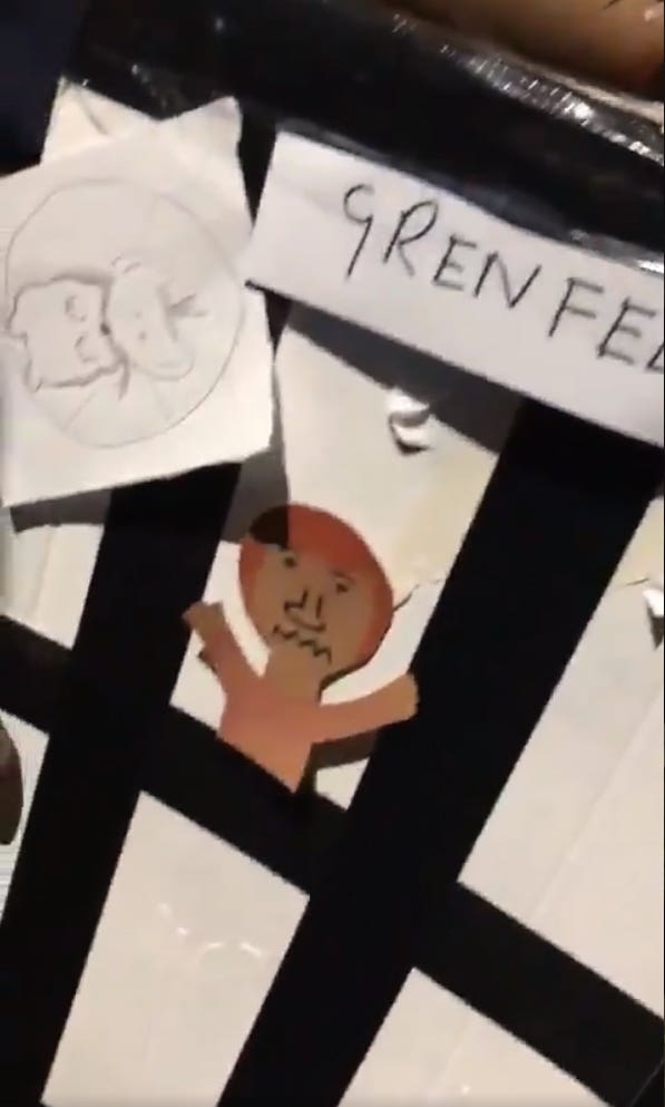 A grab taken from a video posted on social media of a model of Grenfell Tower being burned over a fire