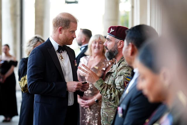 Harry speaks to a guest at the Invictus Spirit Awards