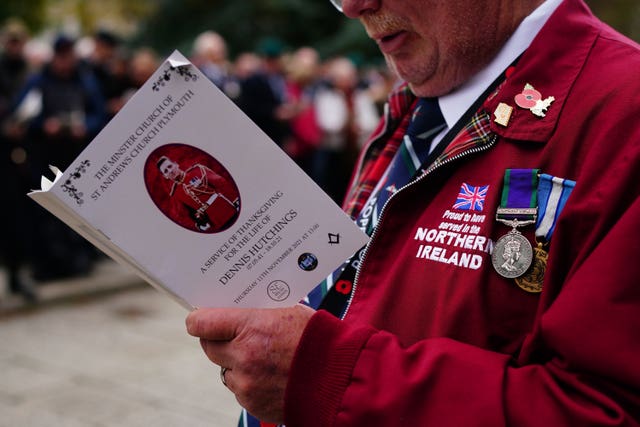 A member of the public reads an order of service during the funeral of Dennis Hutchings, who died after contracting Covid-19 while he was in Belfast to face trial over a fatal shooting incident in Co Tyrone in 1974, at St Andrew’s Church in Plymouth